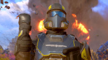 Helldivers 2 loadout request: a soldier in black and yellow giving a salute in front of an explosion