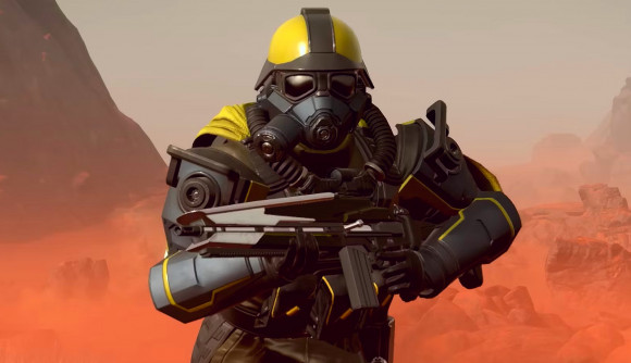 Helldivers 2 update: A Helldiver in a black and yellow suit runs through a desert with a weapon in hand