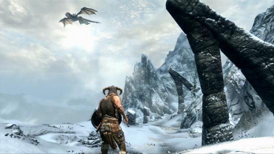 Best Christmas games - the Dovakin is looking at a dragon flying high in the mountains in The Elder Scrolls V: Skyrim.